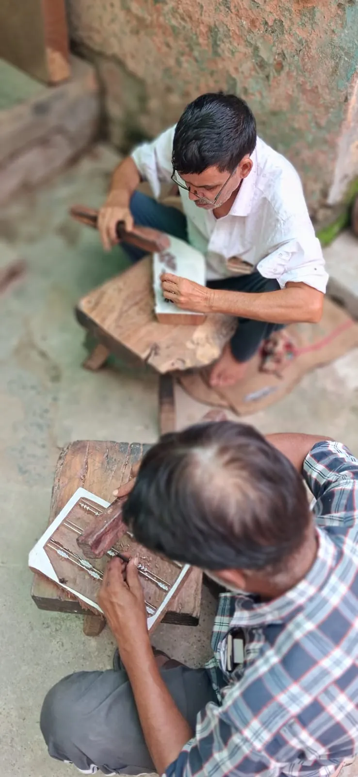 Artisans hand carving border and motif print blocks from seasoned wood