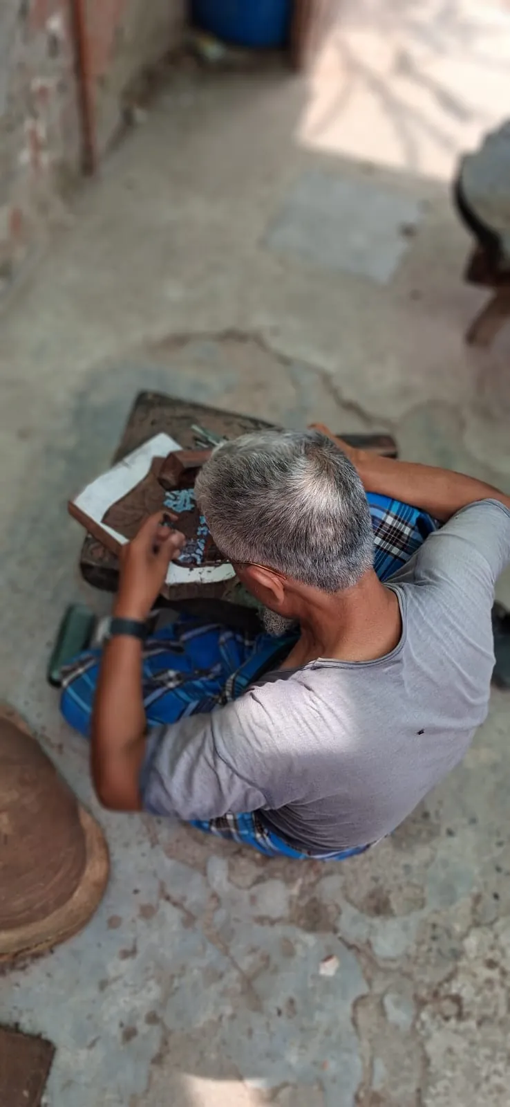 Master block carver at Fabloom cutting fine detail into a wooden printing block