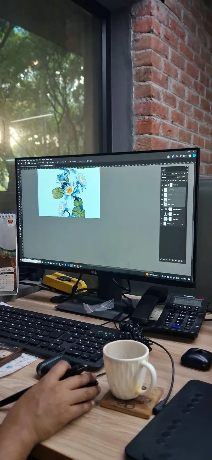 Blue water lily print artwork being built in layers on a designer's monitor