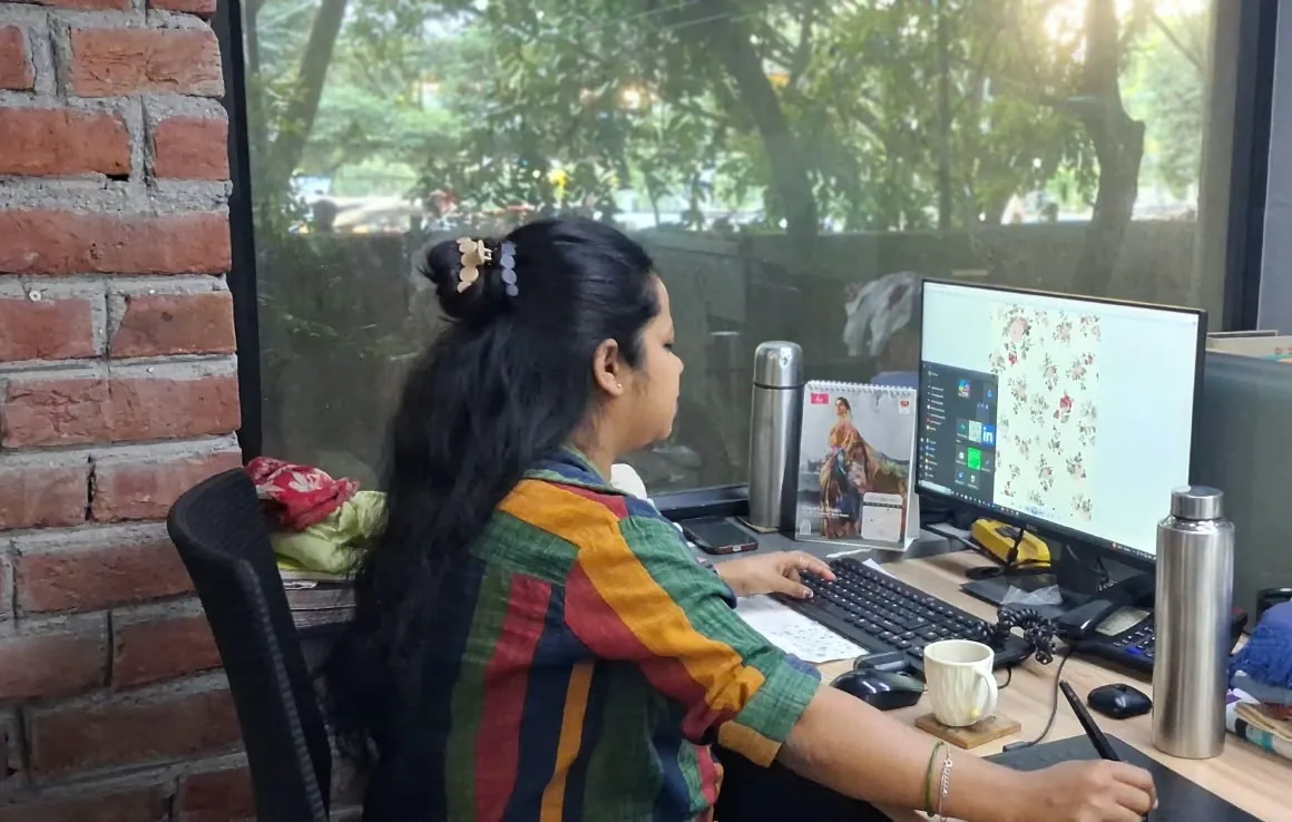 Fabloom textile designer working on a rose floral repeat with a pen tablet in the design studio